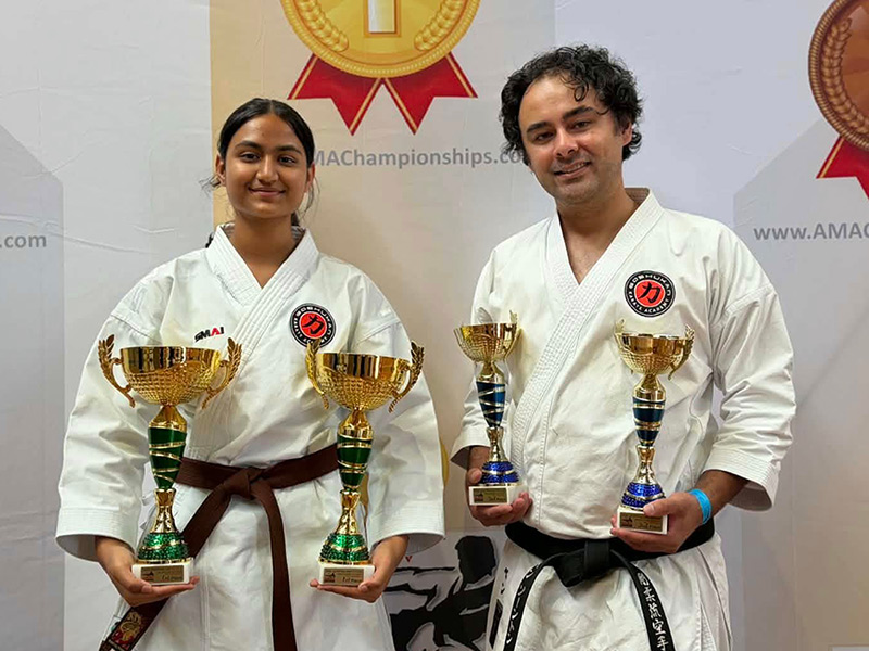 Alaina Makkar and Ben Thornton proudly holding their AMAC 2025 National Titles trophies.