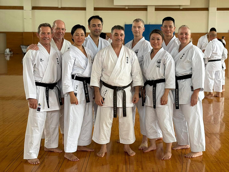 Members of Goshukan Karate Academy pose for a group photo inside Omagari Gymnasium, Japan