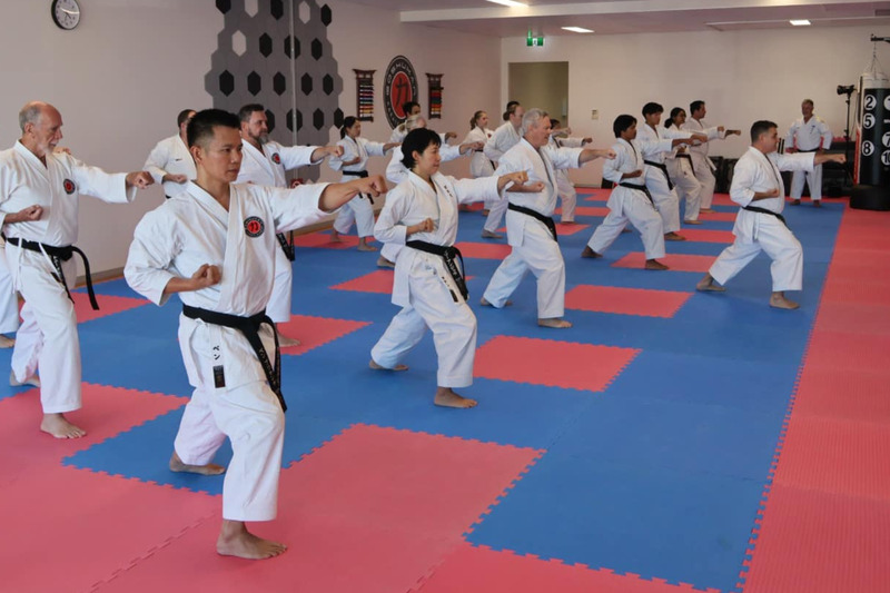 Students drilling the gyaku zuki (reverse punch) during training